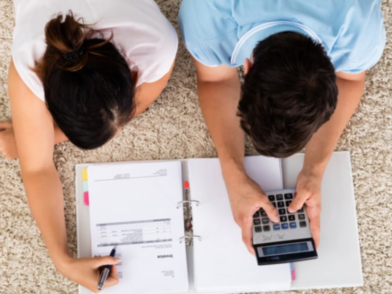 Couple planning their financial future with documents and calculator