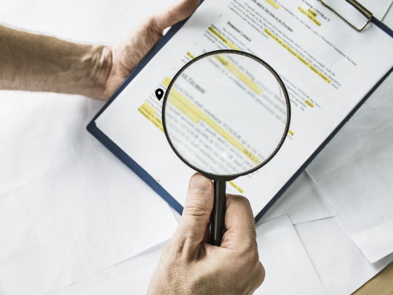 Can You Lease a Car with Bad Credit — magnifying glass over contract showing fine print
